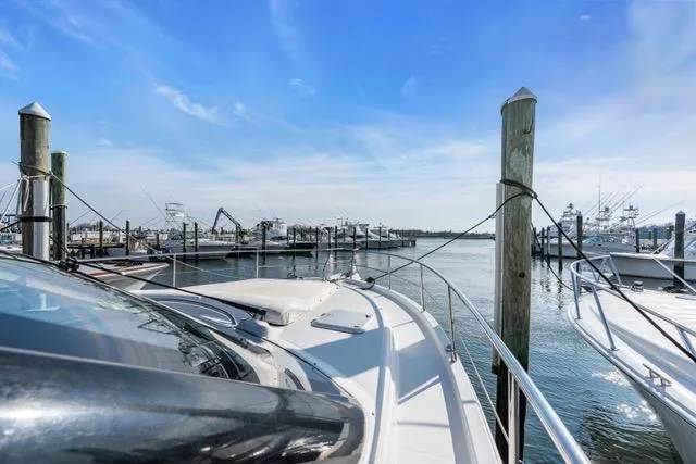 Ayeroller Yacht Photos Pics 2014 Riviera 4400 Sport Yacht docked at marina under clear blue sky.