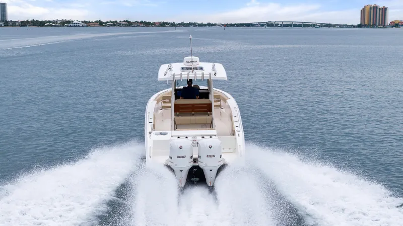Little Perspective Yacht Photos Pics 2019 Pursuit S 288 Sport boat cruising on open water, rear view.