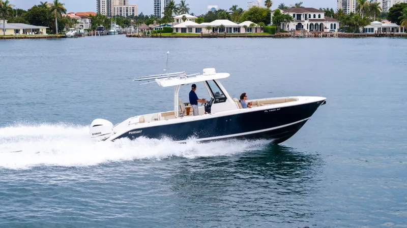 Little Perspective Yacht Photos Pics 2019 Pursuit S 288 Sport boat cruising on water near waterfront homes.