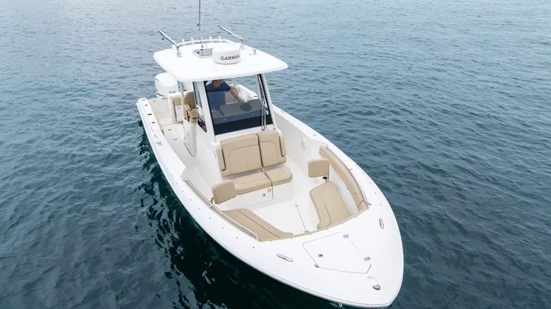 Little Perspective Yacht Photos Pics 2019 Pursuit S 288 Sport boat on calm water, featuring sleek design and comfortable seating.