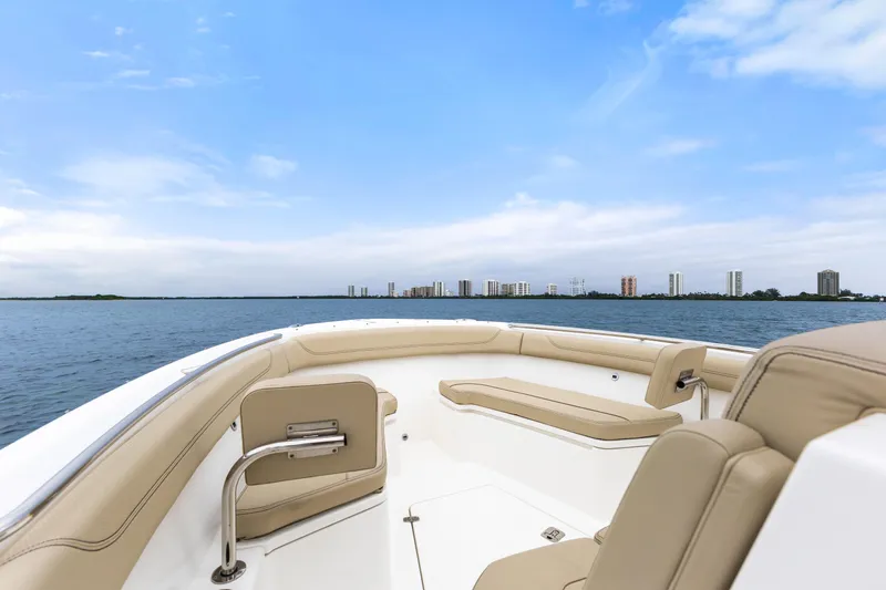 Little Perspective Yacht Photos Pics 2019 Pursuit S 288 Sport boat interior with city skyline and blue sky background.