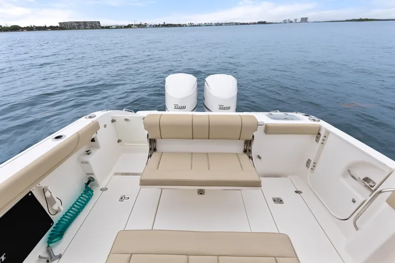 Little Perspective Yacht Photos Pics 2019 Pursuit S 288 Sport boat interior with seating and dual engines on open water.