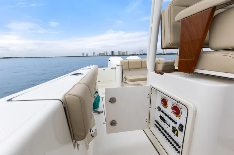 Little Perspective Yacht Photos Pics 2019 Pursuit S 288 Sport boat interior with control panel, beige seating, and ocean view.