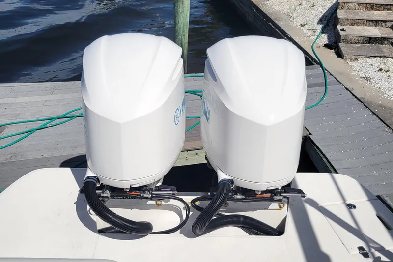  Yacht Photos Pics Twin outboard engines on a 2020 Regal 29 OBX boat docked by the water.