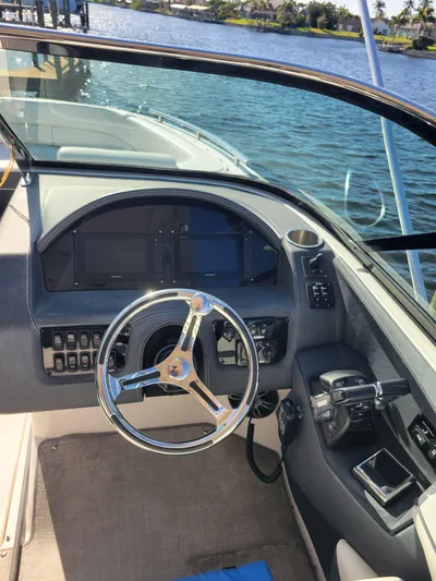  Yacht Photos Pics 2020 Regal 29 OBX boat cockpit with steering wheel and control panel.