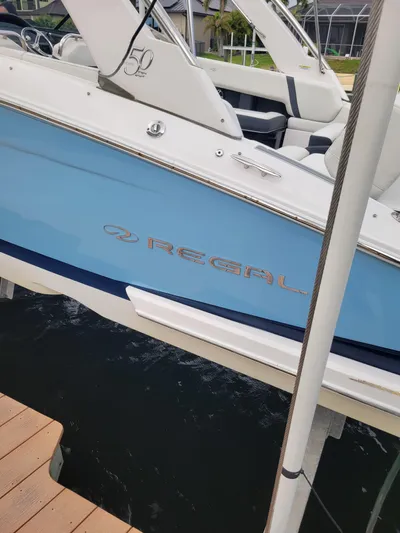  Yacht Photos Pics 2020 Regal 29 OBX boat with blue hull docked at marina.