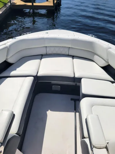  Yacht Photos Pics 2020 Regal 29 OBX boat with spacious seating, docked by the water.