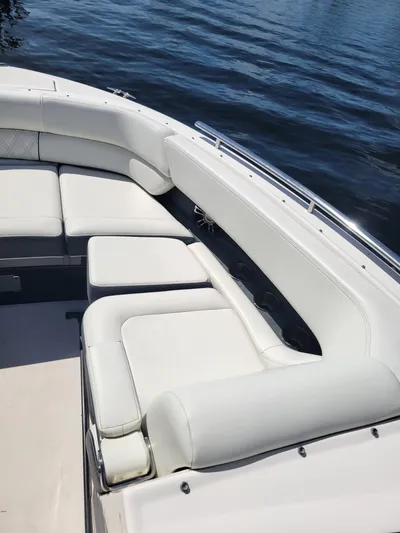  Yacht Photos Pics 2020 Regal 29 OBX boat with white cushioned seating on calm water.