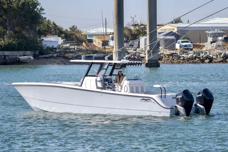  Yacht Photos Pics 2022 Invincible 33 Catamaran cruising on water with dual outboard engines.
