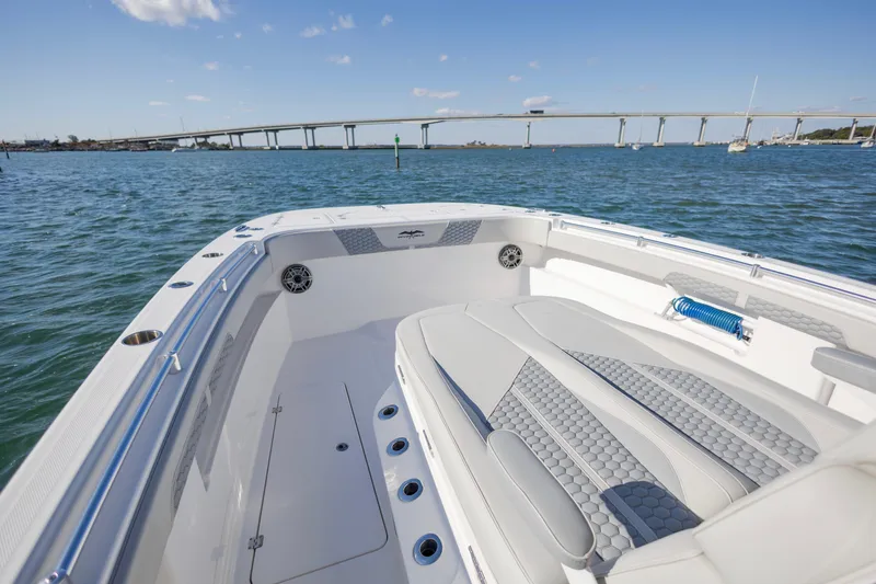  Yacht Photos Pics 2022 Invincible 33 Catamaran on water, bridge in background, sunny day.