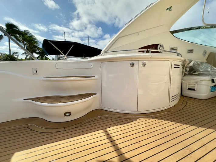  Yacht Photos Pics 1999 Sea Ray 540 Sundancer yacht deck with sleek white cabinetry and wooden flooring.