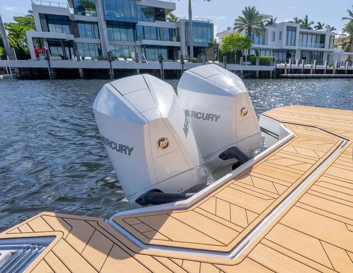 Custom Order Your 347 Today! Yacht Photos Pics 2025 Hanover 347 Outboard boat with dual Mercury engines docked by waterfront homes.