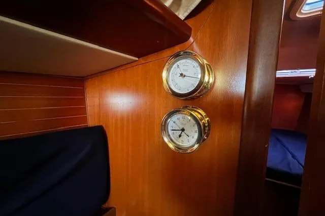 Eagles Wings Yacht Photos Pics Interior of 2003 Grand Soleil 44 yacht with brass instruments on wooden paneling.