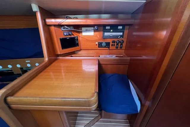 Eagles Wings Yacht Photos Pics Navigation station in 2003 Grand Soleil 44 yacht with wooden desk and control panel.