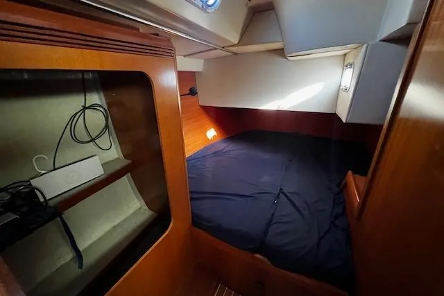 Eagles Wings Yacht Photos Pics Cozy cabin interior of 2003 Grand Soleil 44 sailboat with wooden finish and bedding.