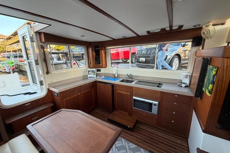 Blue Heron Yacht Photos Pics Interior of 2015 Nordic Tug 34, featuring a modern kitchen with wood cabinetry.