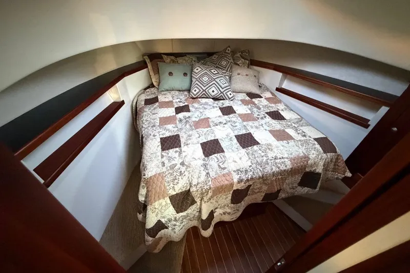 Blue Heron Yacht Photos Pics Cozy cabin interior of 2015 Nordic Tug 34 with quilted bedding and decorative pillows.