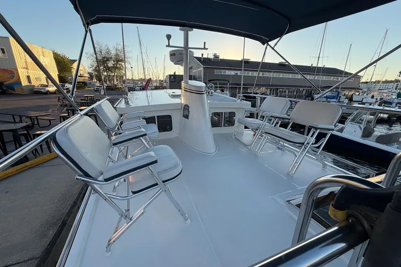 Blue Heron Yacht Photos Pics Nordic Tug 34 (2015) boat deck with seating, docked at marina during sunset.