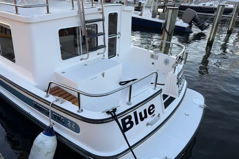 Blue Heron Yacht Photos Pics 2015 Nordic Tug 34 docked, featuring a spacious deck and sleek design.