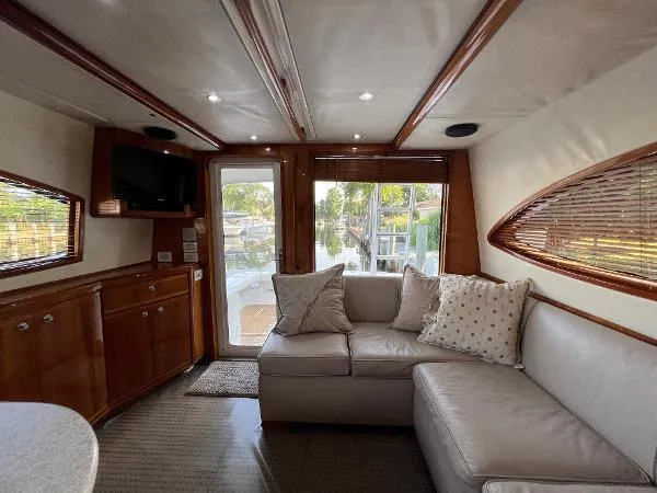 Yacht Photos Pics Interior of 2001 Bertram 39 Convertible yacht with cozy seating and elegant wood finishes.
