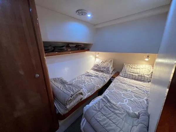  Yacht Photos Pics 2001 Bertram 39 Convertible cabin with twin beds and cozy lighting.