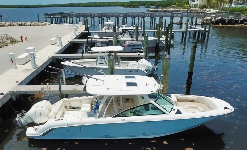 Born Free Yacht Photos Pics 2017 Boston Whaler 320 Vantage docked at a marina with other boats.