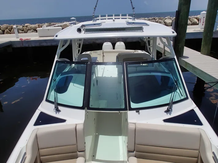 Born Free Yacht Photos Pics 2017 Boston Whaler 320 Vantage boat docked, featuring spacious seating and sleek design.