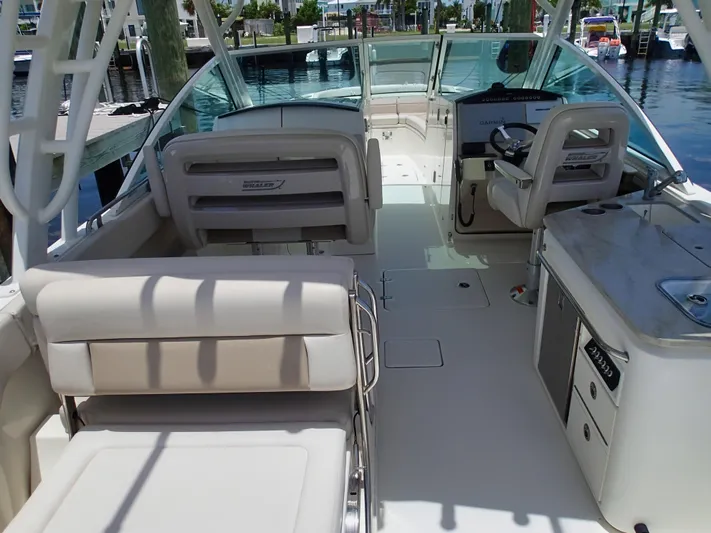 Born Free Yacht Photos Pics 2017 Boston Whaler 320 Vantage boat interior with seating and helm, docked at marina.