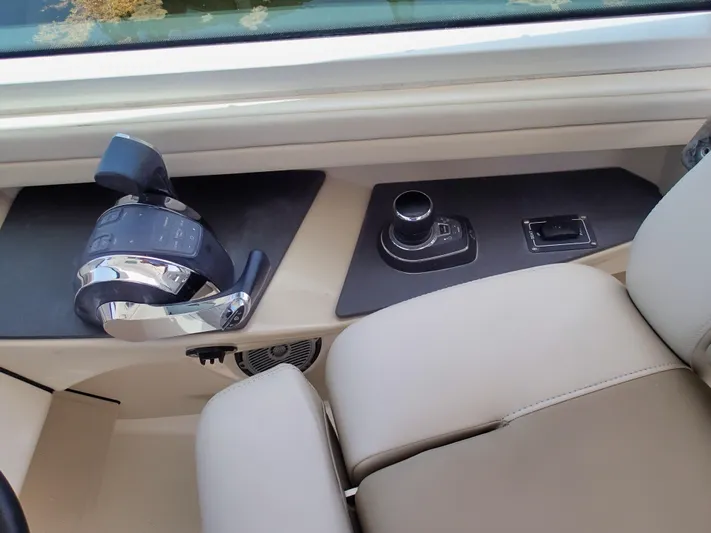 Born Free Yacht Photos Pics 2017 Boston Whaler 320 Vantage helm controls with beige seating and modern dashboard.