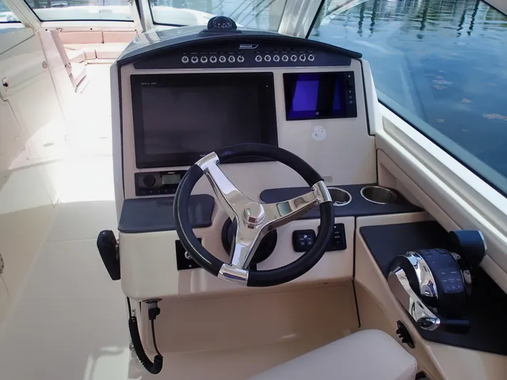 Born Free Yacht Photos Pics 2017 Boston Whaler 320 Vantage helm with modern controls and navigation system.