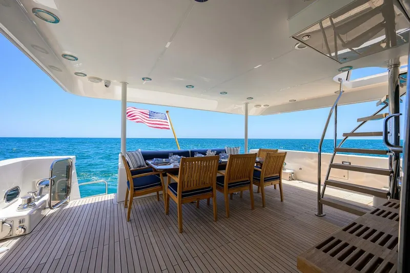 Jule Yacht Photos Pics Luxury dining area on 2005 Pacific Mariner 85 yacht with ocean view and American flag.