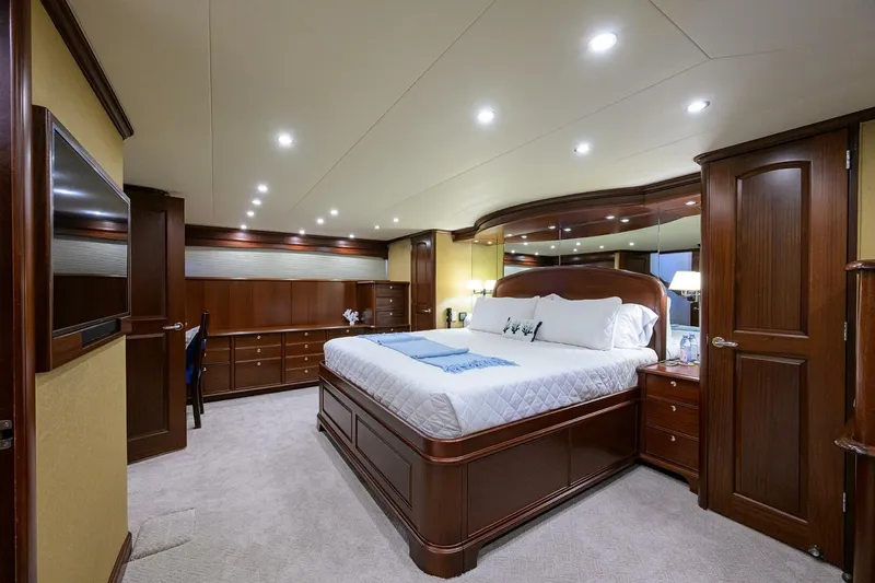 Jule Yacht Photos Pics Luxurious bedroom interior of 2005 Pacific Mariner 85 yacht with elegant wood furnishings.