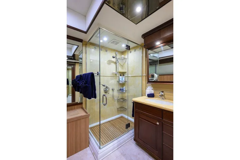 Jule Yacht Photos Pics Luxurious bathroom on 2005 Pacific Mariner 85 yacht with glass shower and wooden accents.