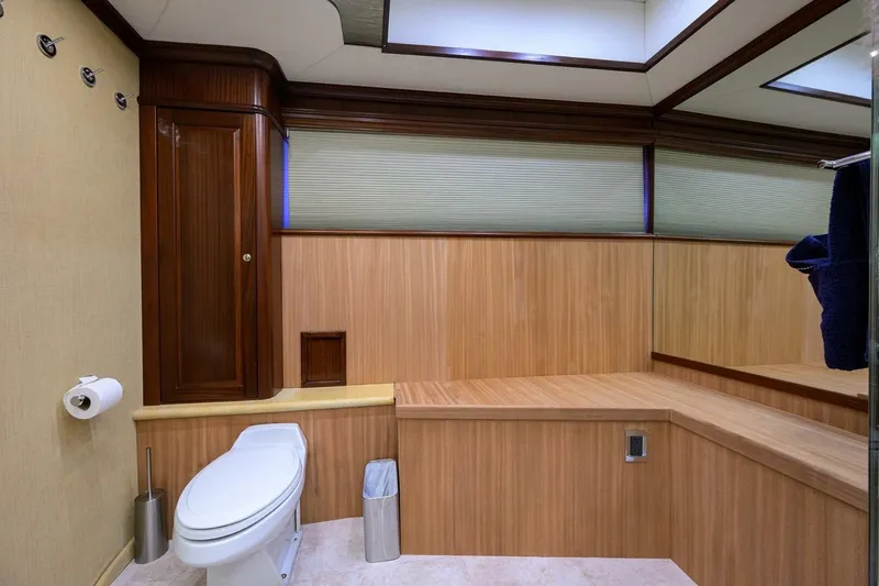 Jule Yacht Photos Pics Luxurious bathroom in 2005 Pacific Mariner 85 yacht with wood paneling and modern fixtures.