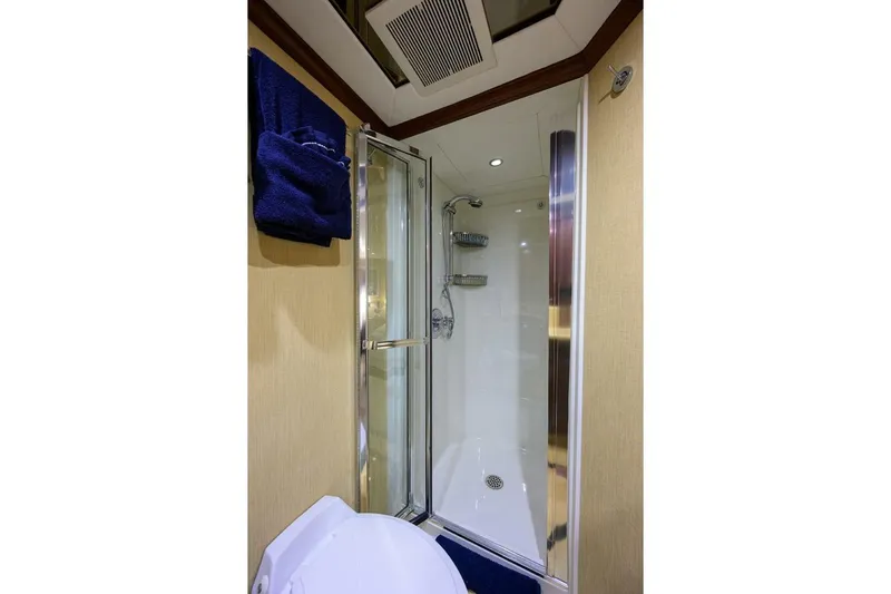 Jule Yacht Photos Pics Luxurious bathroom in 2005 Pacific Mariner 85 yacht with shower and blue towels.