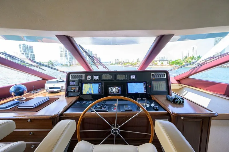 Jule Yacht Photos Pics Helm of 2005 Pacific Mariner 85 yacht with navigation equipment and city skyline view.