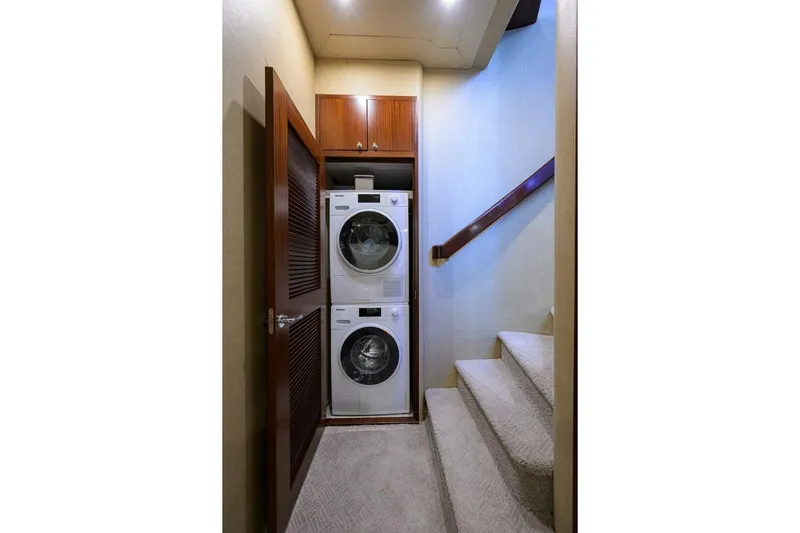 Jule Yacht Photos Pics Laundry area with stacked washer and dryer in 2005 Pacific Mariner 85 yacht.