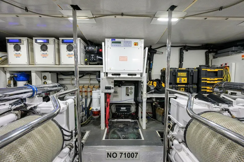 Jule Yacht Photos Pics Engine room of a 2005 Pacific Mariner 85 yacht, featuring equipment and storage.