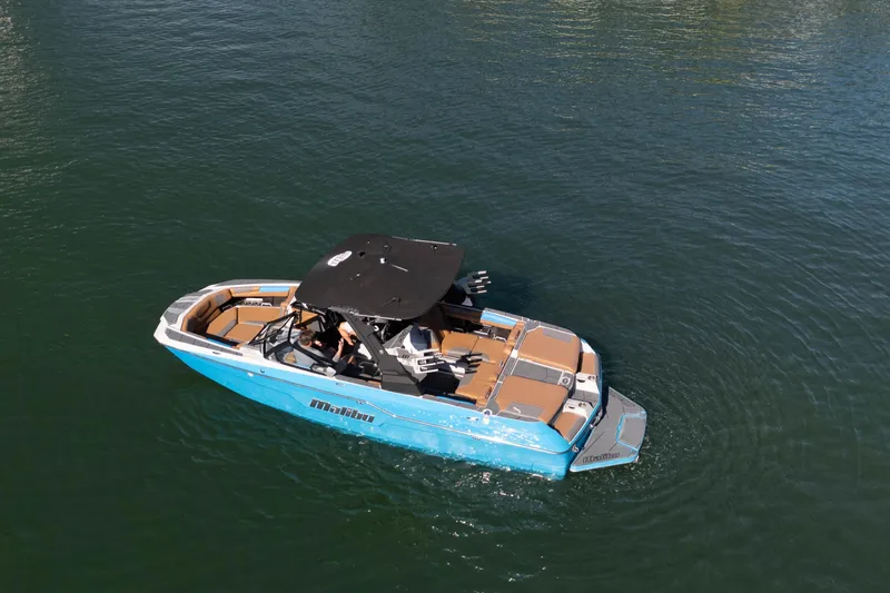  Yacht Photos Pics 2020 Malibu M240 boat on calm water, featuring sleek design and spacious seating.