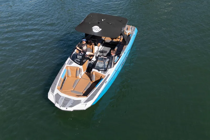  Yacht Photos Pics 2020 Malibu M240 boat cruising on calm water, featuring sleek design and spacious seating.