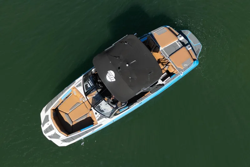  Yacht Photos Pics Aerial view of 2020 Malibu M240 boat on green water.