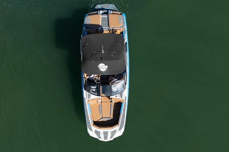  Yacht Photos Pics Aerial view of 2020 Malibu M240 boat on calm green water.