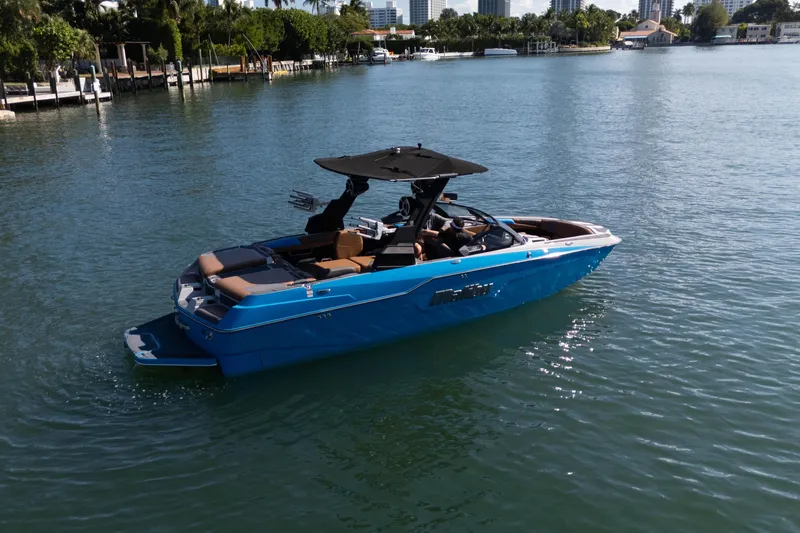  Yacht Photos Pics 2020 Malibu M240 boat cruising on a sunny, calm waterway.