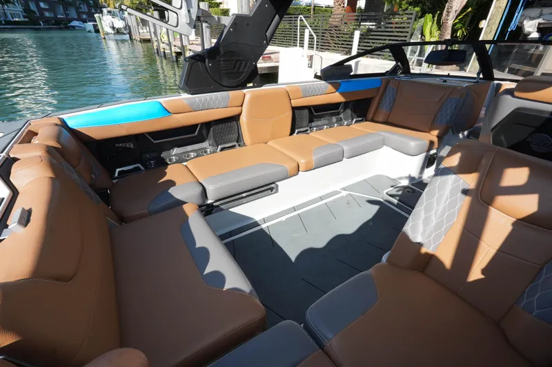 Yacht Photos Pics Luxurious interior of 2020 Malibu M240 boat with tan and gray seating.