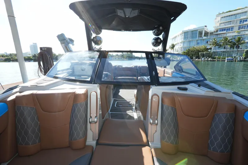  Yacht Photos Pics 2020 Malibu M240 boat interior with luxurious seating and modern design on a sunny day.