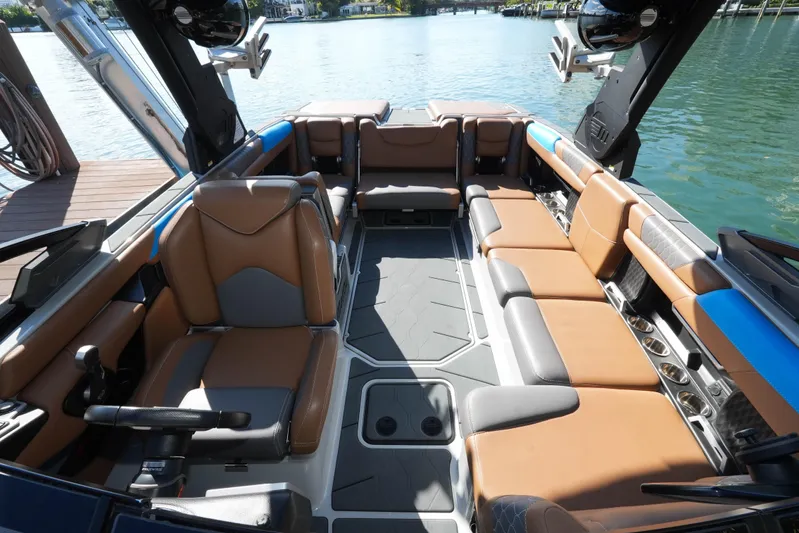  Yacht Photos Pics 2020 Malibu M240 boat interior with luxurious seating and modern design on a sunny day.