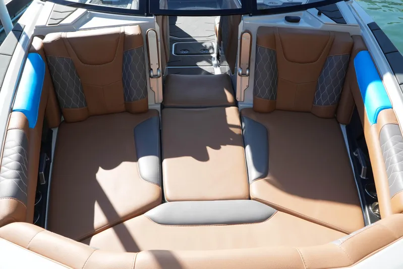 Yacht Photos Pics 2020 Malibu M240 boat interior with brown and blue cushioned seating.
