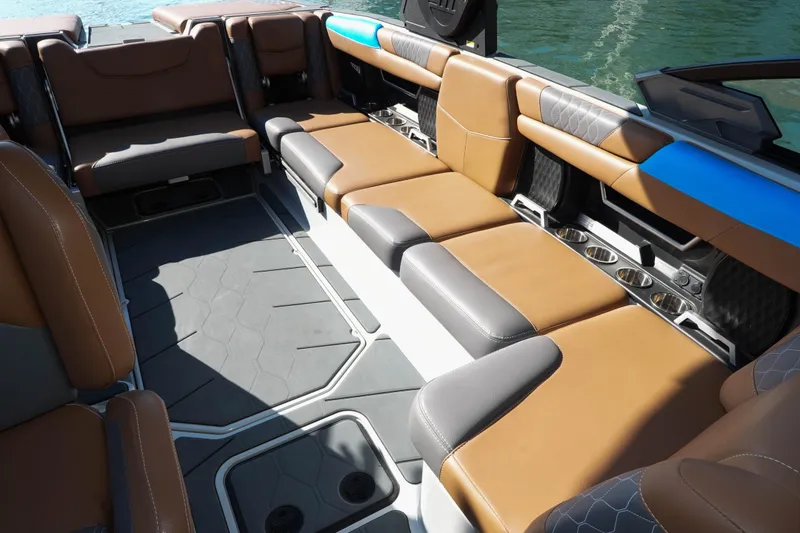  Yacht Photos Pics 2020 Malibu M240 boat interior with luxurious brown and gray seating, cup holders, and sleek design.