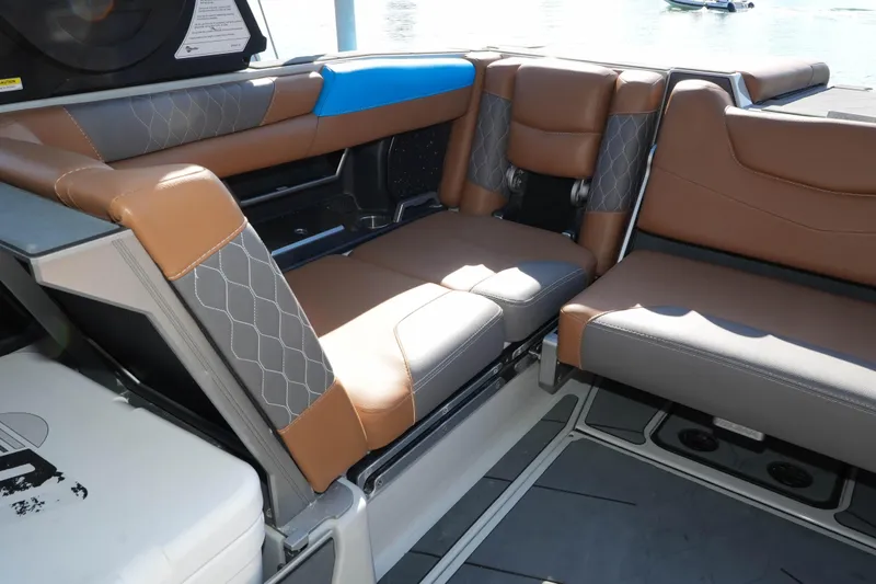  Yacht Photos Pics 2020 Malibu M240 boat interior with brown and gray seating, featuring diamond stitching.