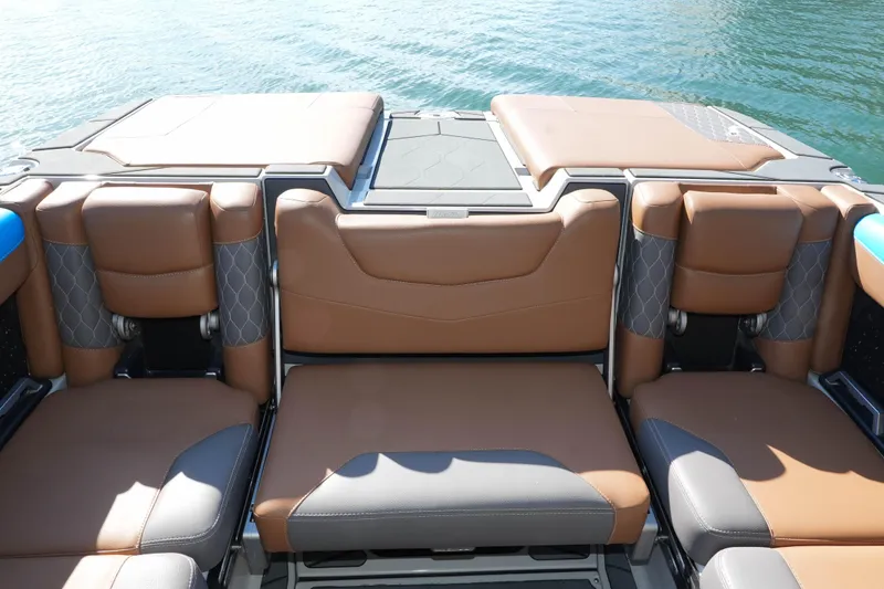  Yacht Photos Pics 2020 Malibu M240 boat interior with brown leather seating, on calm water.